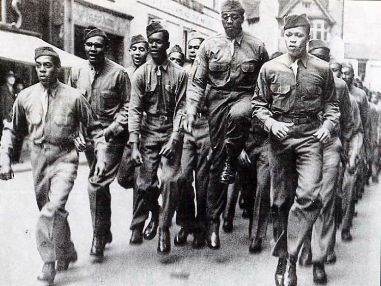 Black American soldiers marching through Bristol, England, during World War II